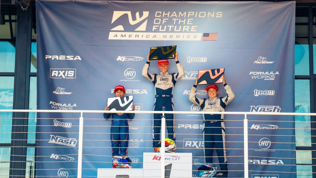 Sebastian Hauser, Troy Ferguson, and Tyren Scott hold awards during the KA100 Junior Champions of the Future America series Round 3 event at K1 Circuit