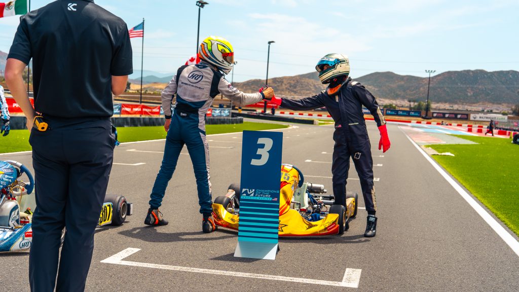 Sebastian Hauser shakes Bronson Koustas's hand at the end of the KA100 Junior Champions of the Future America series race, Round 4