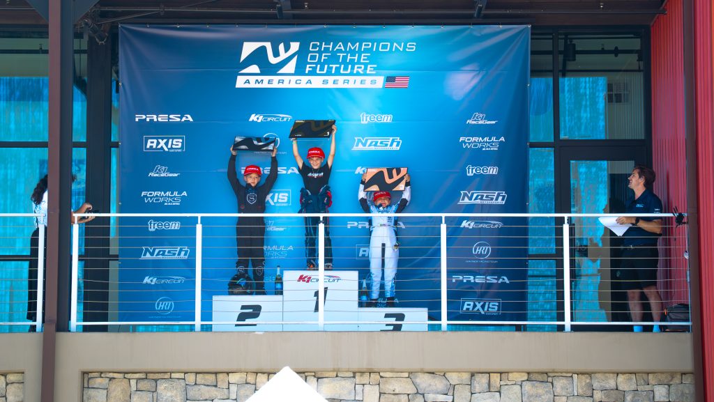 Benjamin Monroy, Lyon McPhail, and Lucas Freitas Melo stand on the podium at K1 Circuit as the top three finishers of Mini U10 at K1 Circuit, Champions of the Future America Series Round 6