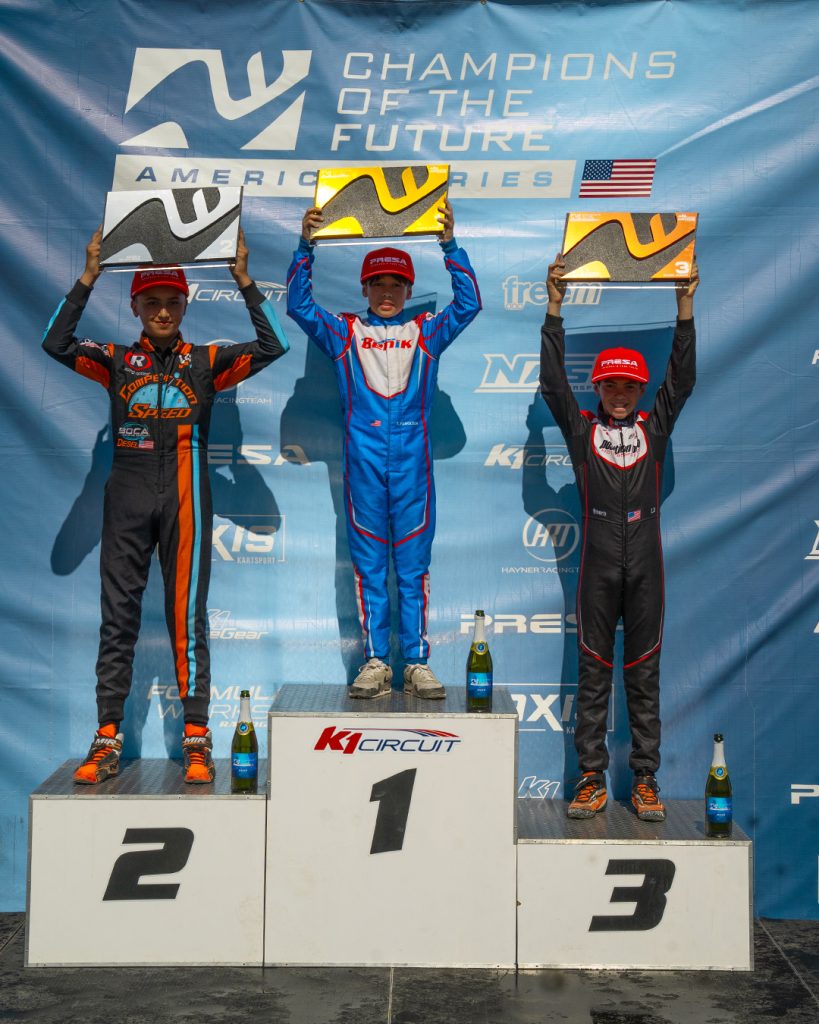 The top three KA100 Junior drivers from COTF America's Round 5 event in Pahrump, NV stand on the podium with their trophies