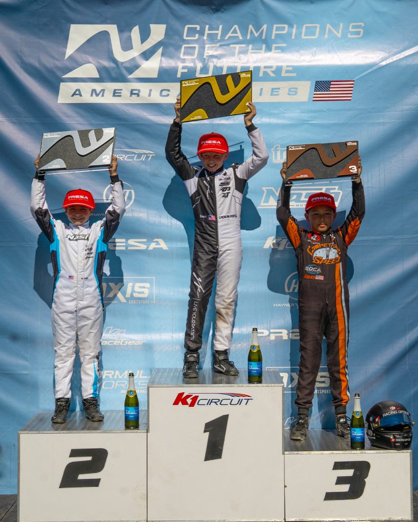 The top three Mini drivers from COTF America's Round 5 event in Pahrump, NV stand on the podium with their trophies