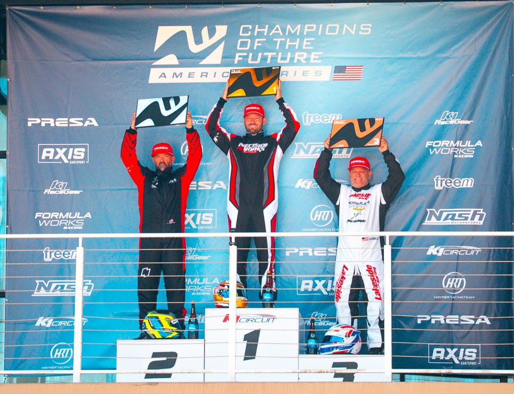 The Top 3 drivers from KA100 Heritage hold up their trophies on the podium during Round 7 of Champions of the Future America